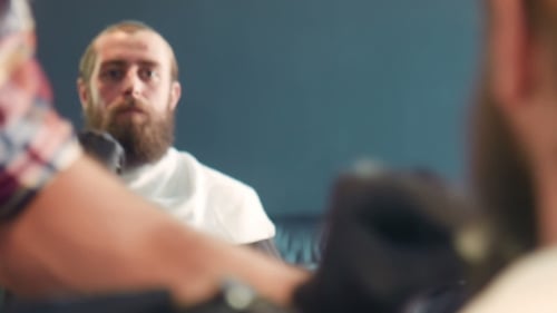 Man at Barber Shop Preparing for Beard Trim