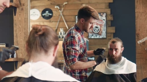 Barber Trimming Beard in Stylish Barber Shop