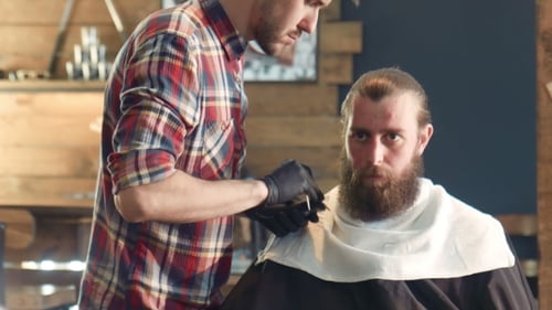 Barber Trims Beard in Stylish Barbershop