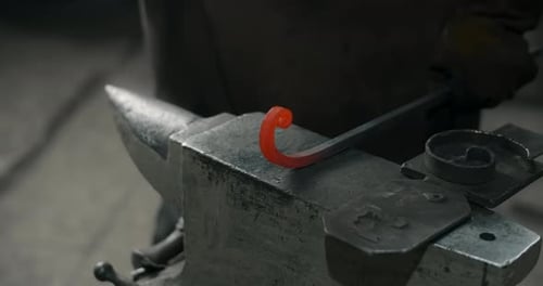 Shaping Hot Metal on Anvil in Workshop