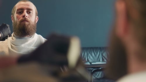 Man Brushing Beard in Mirror Close Up