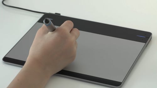 Hand Using Stylus on Graphics Tablet Device