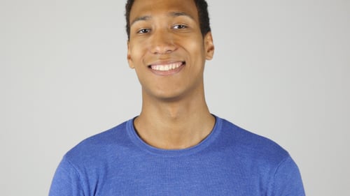 Happy Young Man Smiling in Studio Close Up