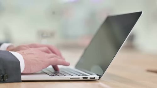 Hands Typing on a Laptop Keyboard