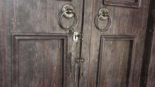 Animation of wooden doors with vintage golden knobs and lock with keyring. 4KHD