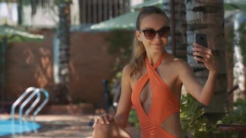 Girl Makes Selfie with Mobile Against Pool at Home