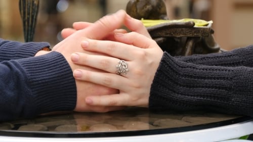 Happy Couple Holding And Touching Each Others Hands At Cafe In Shopping Mall.