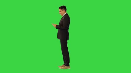 Man in Suit Using Phone on Green Screen