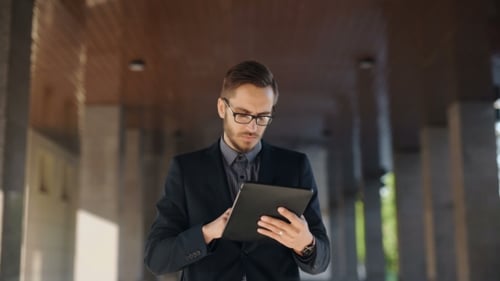 Young Adult Man Using Tablet in City