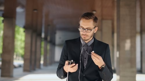Handsome Young Manager With Smartphone In London