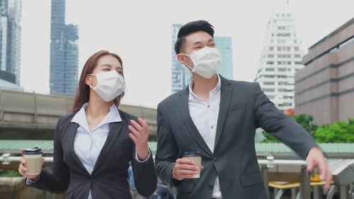 Asian couple office business people stand outdoor in city with confident face holding hot coffee.