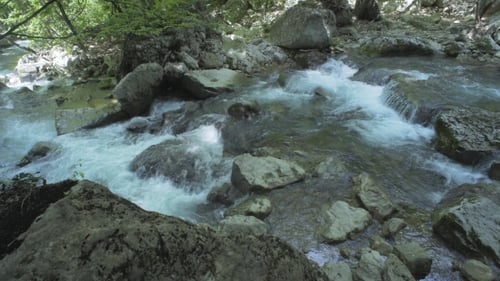 Stones And Mountain River With Small Waterfall