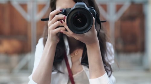 Woman With Camera On The Street.