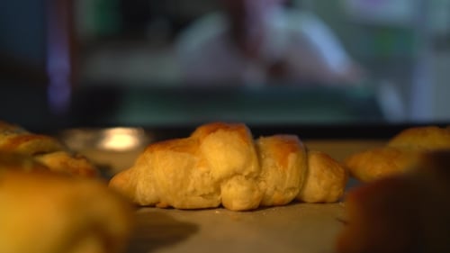 Fresh Golden Croissants Baking in Oven, Close Up