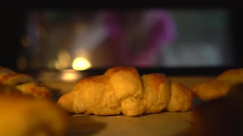 Golden Croissants Baking on Sheet Pan