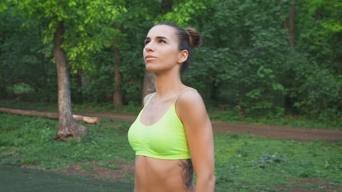 Woman Doing Shoulder Exercise in Green Park