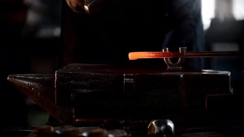 Blacksmith Workshop a Man Bends a Piece of Metal with Hitting It with a Hammer