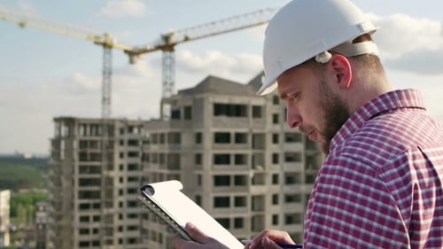 Engineer Looking On Project On Construction Site