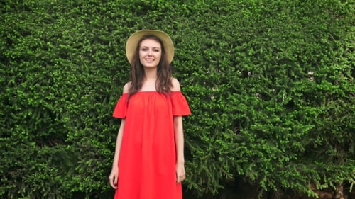 Woman in Red Dress Posing in a Garden