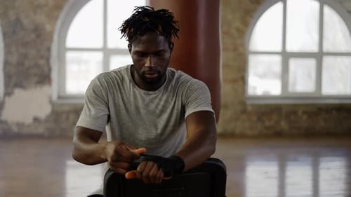 Boxer Wrapping Hands Before Training in Gym