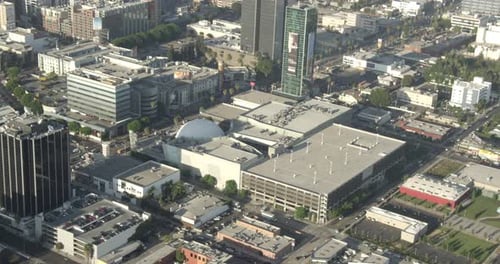 Aerial helicopter shot tracking forward over freeway in between residential area, day