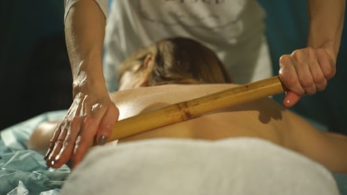 Woman Receiving a Relaxing Bamboo Back Massage