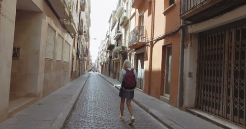 Young Tourist Woman Walk Alone At The Gothic Streets