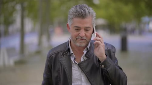 Man Receiving Good News on Phone in Urban Setting