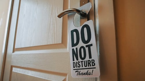 Swinging Do No Disturb Sign at Hotel Room Door
