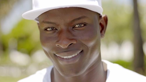 Of Handsome Smiling Black Man In Cap