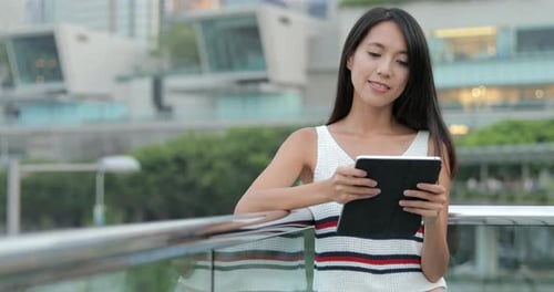 Woman Using Digital Tablet Computer in The City