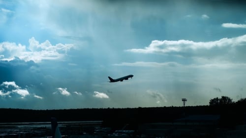 Passenger Plane Fly Up Over Take-off Runway From Airport At Sunset