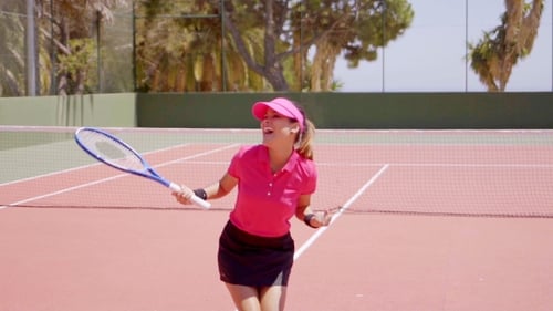 Woman Celebrates Tennis Victory on Court