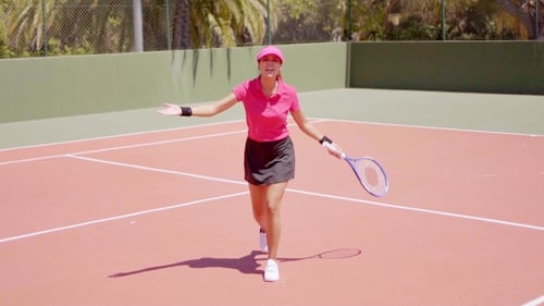 Young Woman Practices Tennis Drills on Court