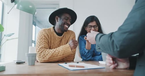 Young Couple Receives Keys in Modern Office