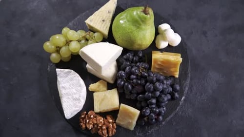 Cheese, Grapes, Pear and Walnuts on Slate Board