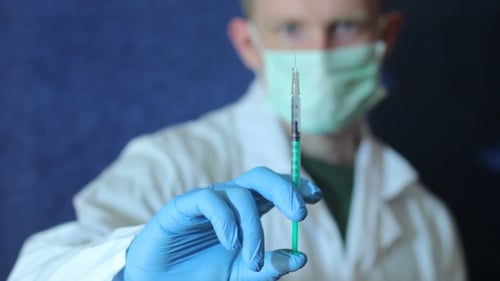Male Doctor Preparing a Syringe For Injection 2