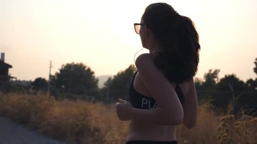 Follow to Sporty Girl Jogging in Country Road