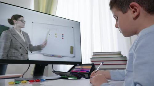 Modern School, a Cute Male Child Teaches Online Lessons with His Teacher From the Video Broadcast