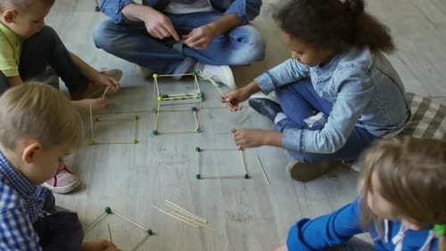 Preschool Kids Making Wooden Cubes with Male Teacher