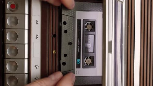 Inserting Cassette Tape into Vintage Player to Play Music