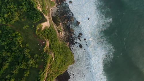 Aerial view of waves breaks on rocky shore. Seascape, rocks, ocean.