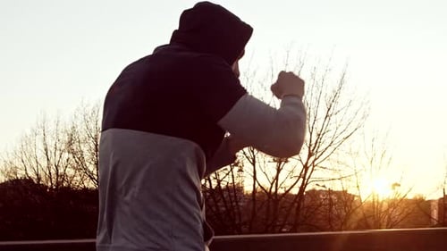 Man Shadow Boxing at Sunrise for Fitness