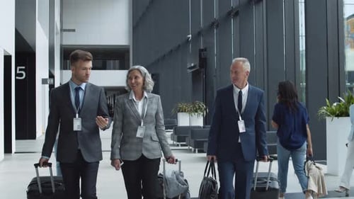 Three Business Colleagues Having Talk in Airport