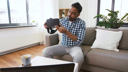 Adult Demonstrates Virtual Reality Headset in Home