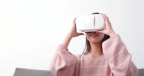 Woman watching with VR device at home