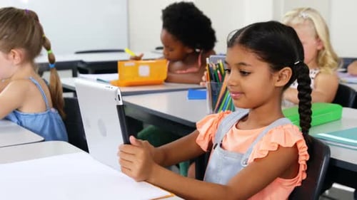 Children Using Tablets in Elementary School Classroom