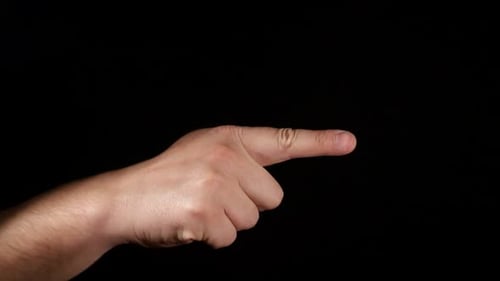 Hand Points Index Finger on Black Background