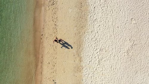 Beautiful fun women relaxing in the sun at the beach on paradise white sand and blue 4K background