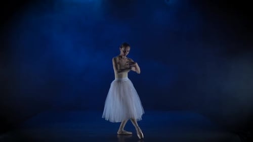 Ballerina in White Tutu Dancing Gracefully on Stage